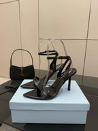 Black strappy high-heel sandals with open toe and slim stiletto heel
