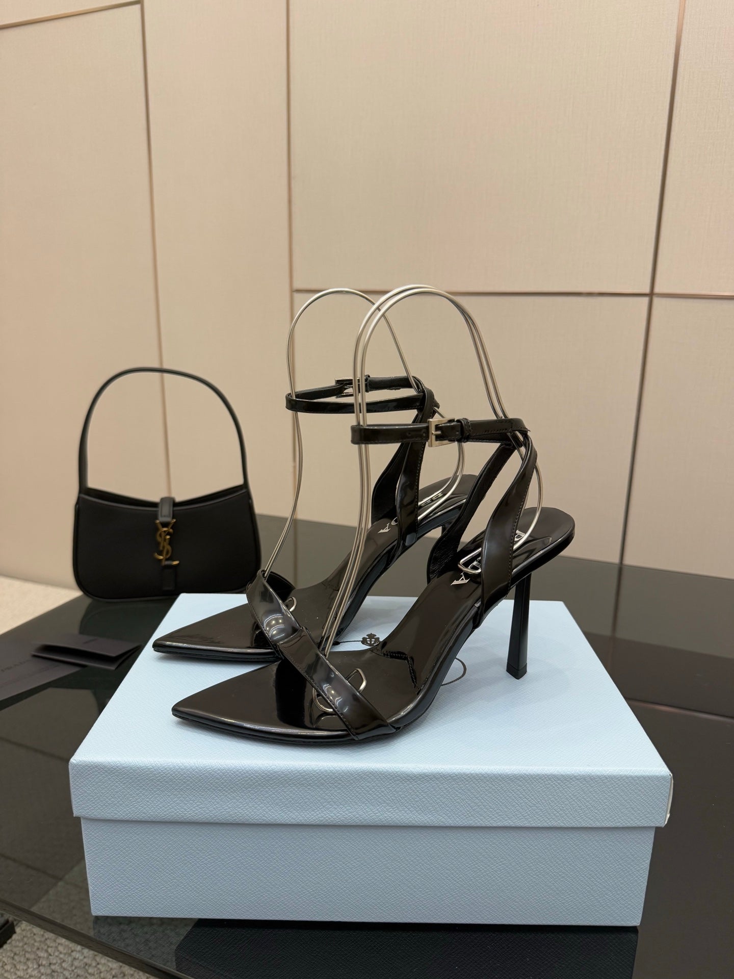 Black strappy high-heel sandals with open toe and slim stiletto heel