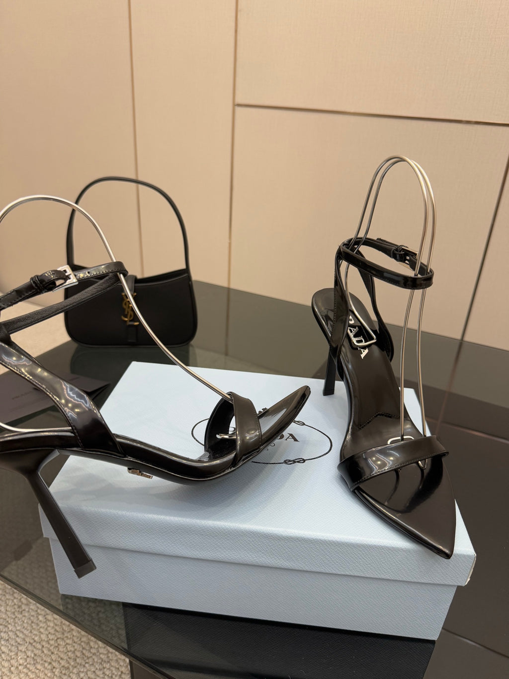 Black patent high-heel sandals with open toe and ankle strap, close side view