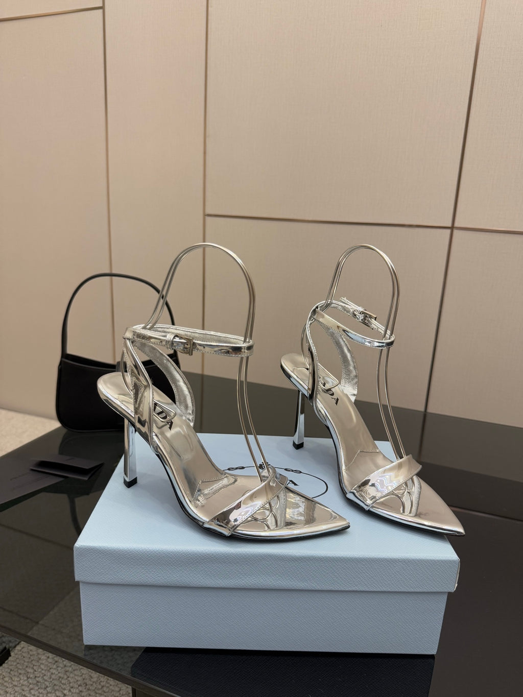 Prada women's metallic silver heeled sandals with stiletto heels, side view