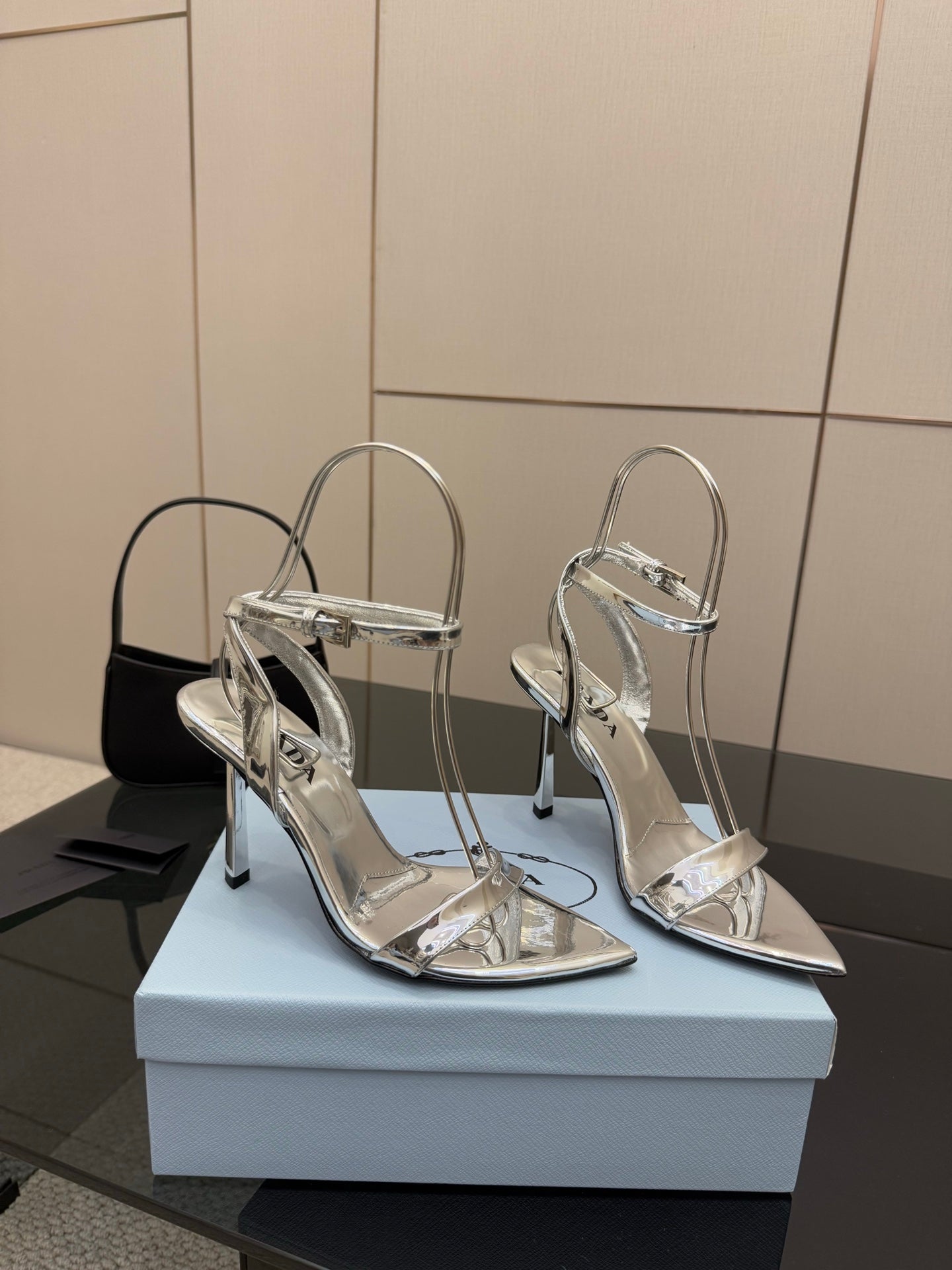 Prada women's metallic silver heeled sandals with stiletto heels, side view