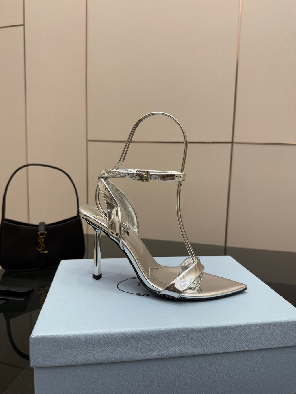 Prada women's metallic silver heeled sandal with single strap and stiletto heel