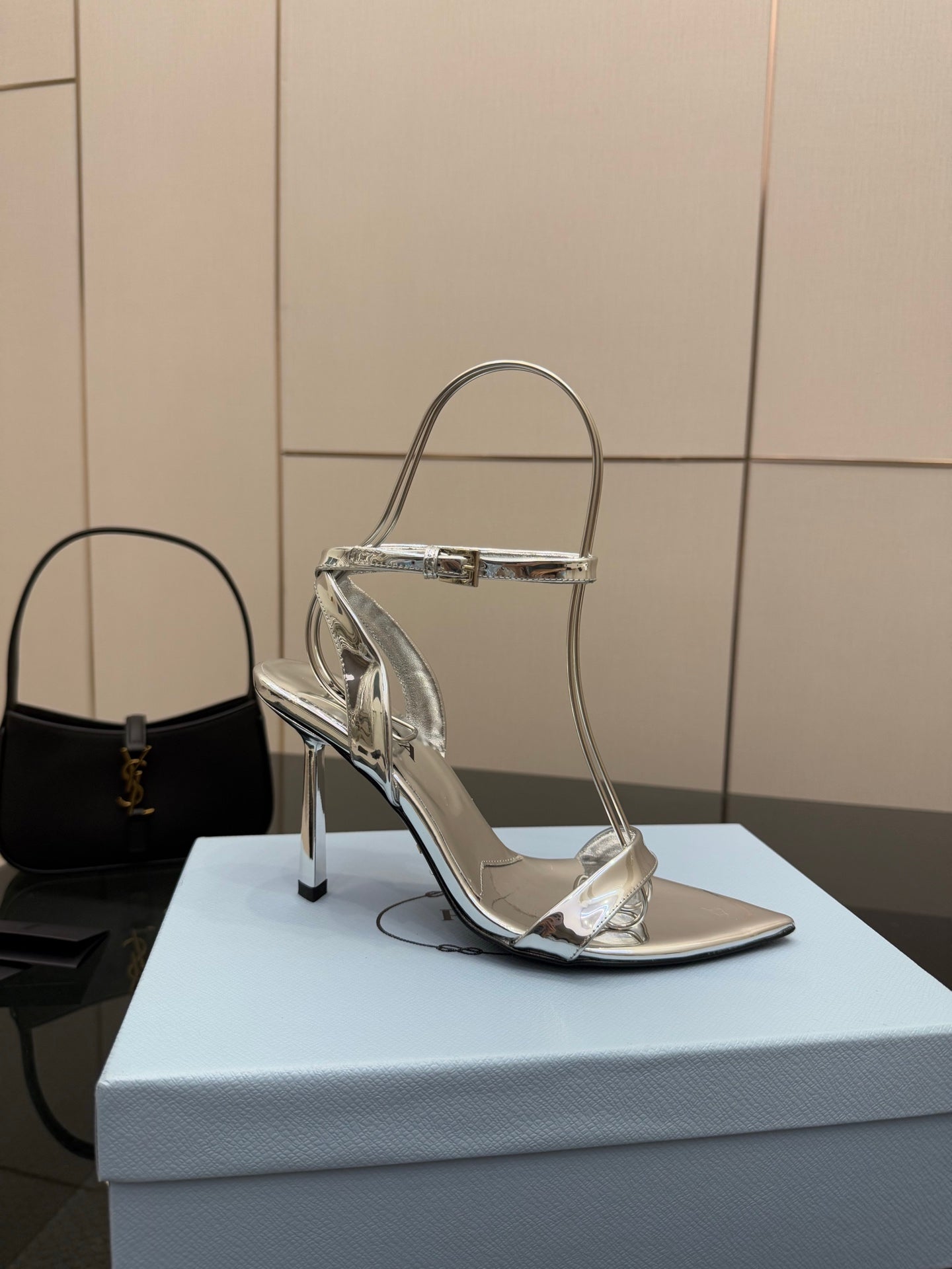 Prada women's metallic silver heeled sandal with single strap and stiletto heel