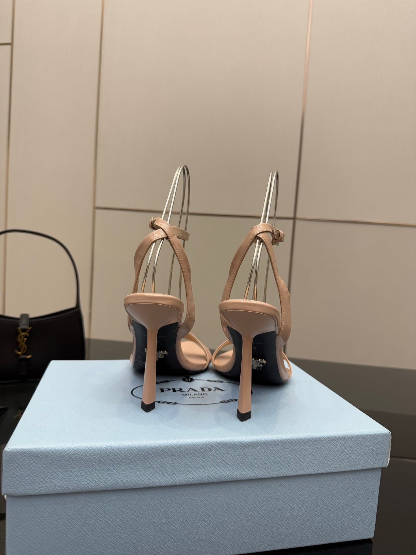 Light nude high-heel sandals with slingback straps and slim stiletto heels, back view