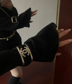 Black fabric cuff bracelet with gold-tone Chanel logo and chain details