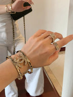 Gold-tone Chanel charm bracelet set on the wrist