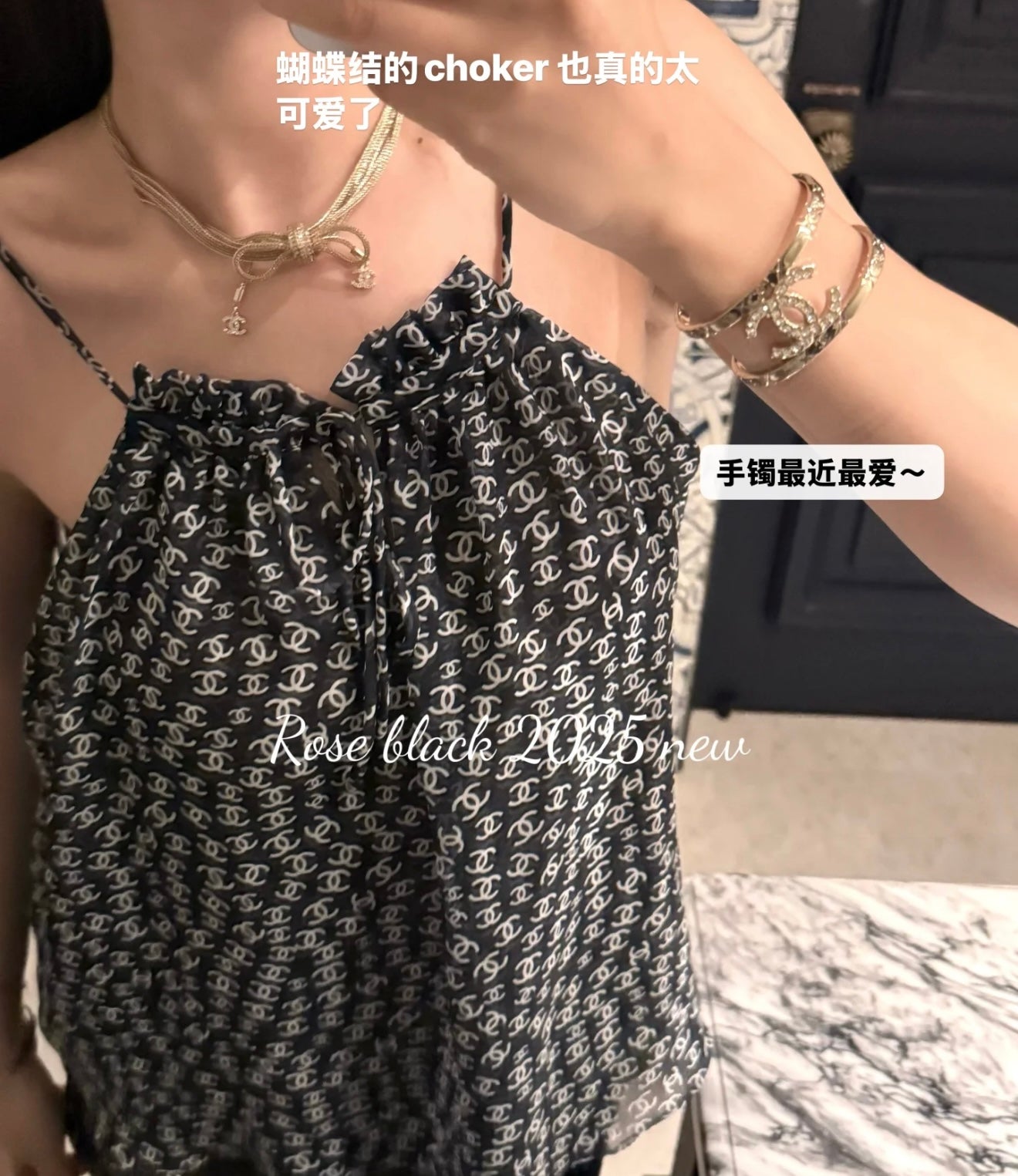 Silver-tone chain choker and layered bracelets with Chanel logo motif