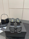 Black patent heeled mules with clear toe strap and ankle wrap detail
