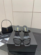 Black patent heeled mules with clear toe strap and ankle wrap detail