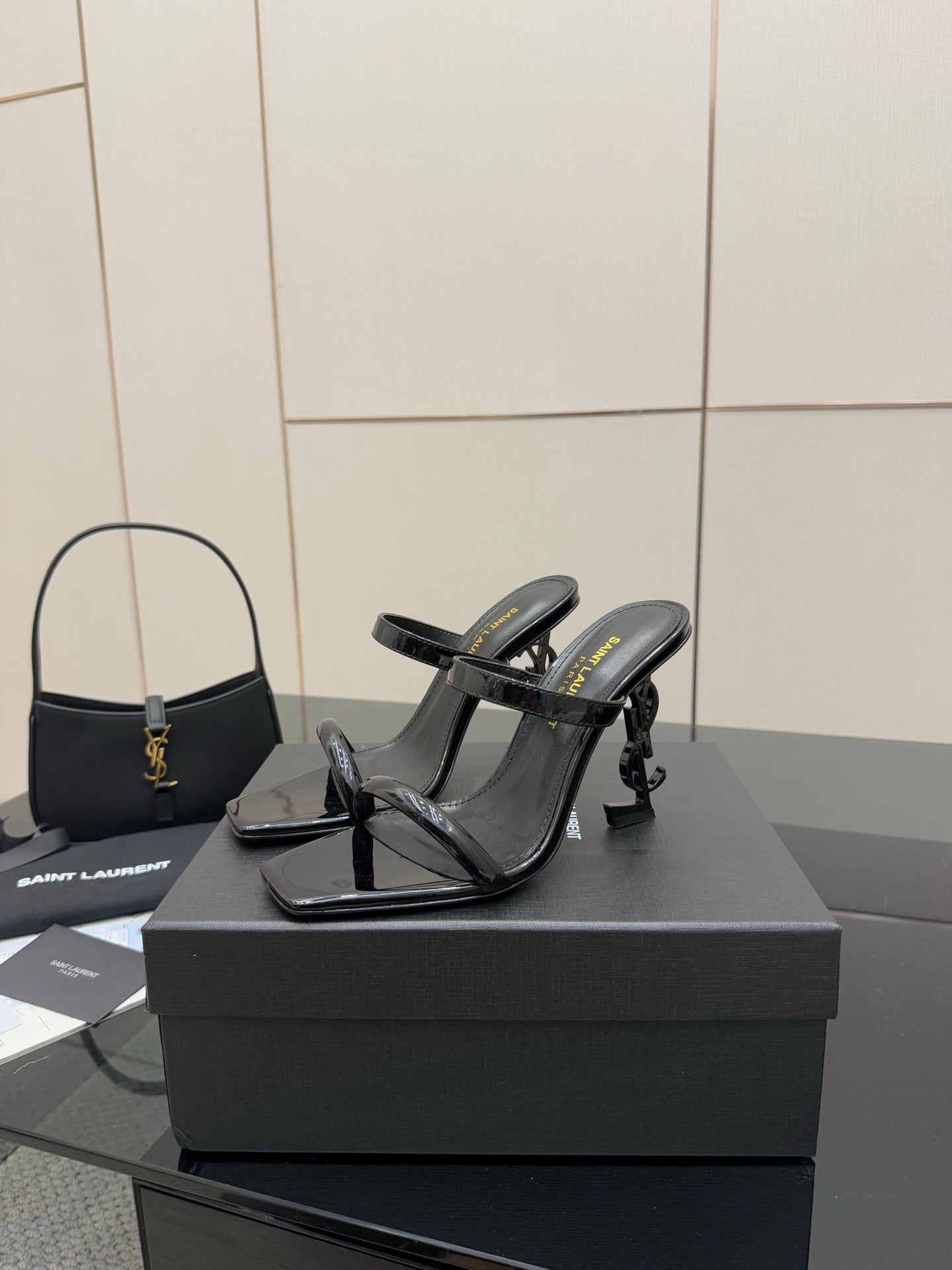 Black patent heeled sandals with open toe and ankle strap, front view