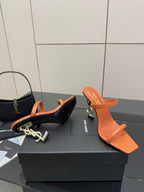 Orange and black YSL mule sandals with open toe and sculpted heels, side-by-side.