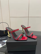 YSL ladies heeled sandals side view, red patent straps with gold logo on heel