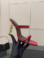 YSL ladies heeled sandal, heel detail view, gold YSL logo charm on red strap