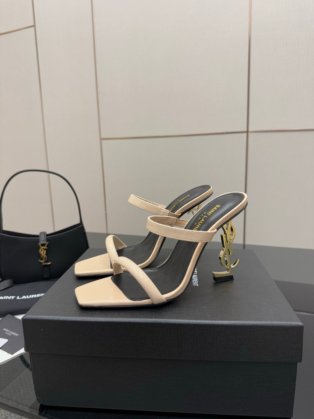 Two-tone heeled mule sandals on black interior with beige strap and low heel