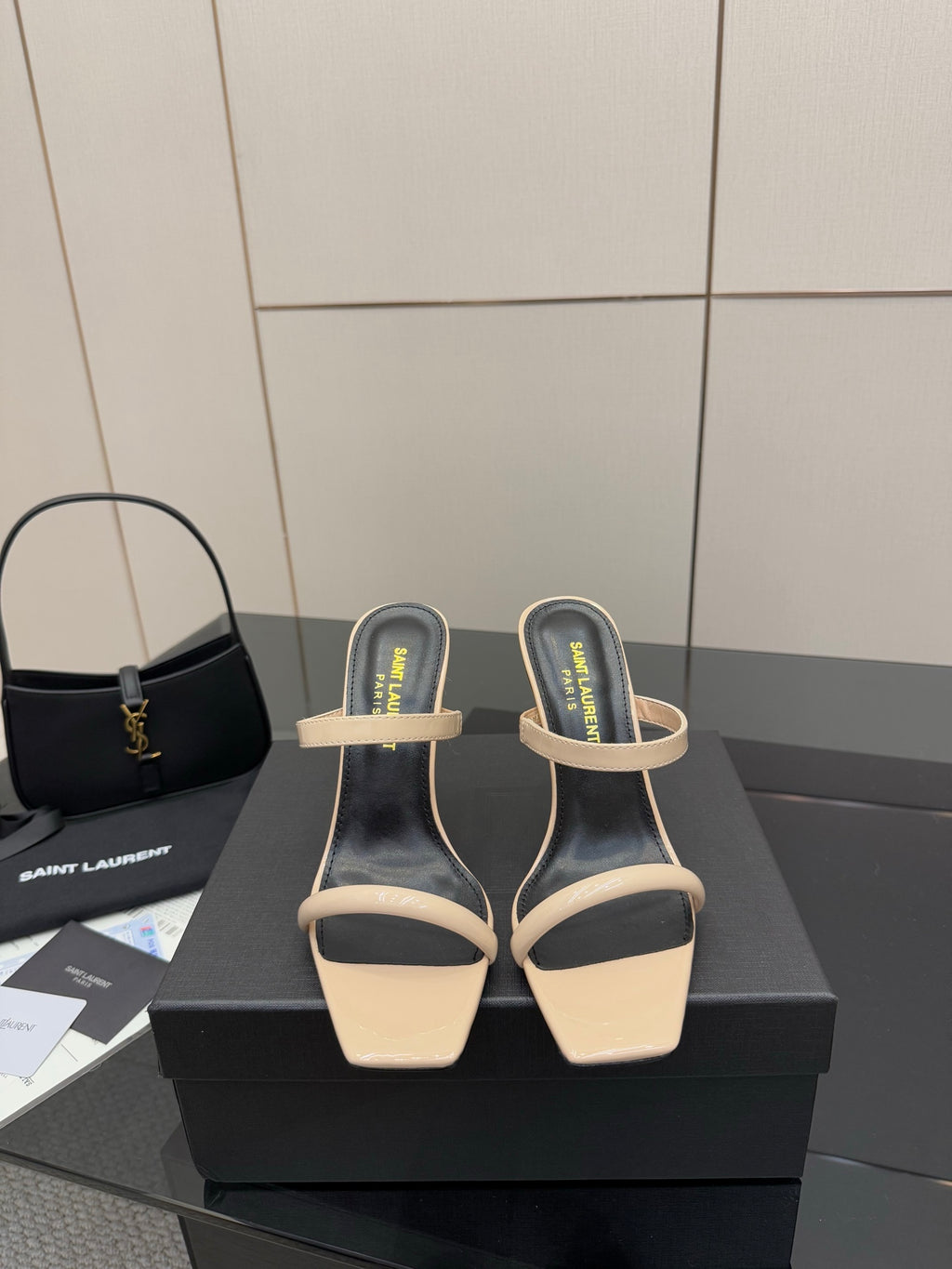 Two-tone heeled mule sandals with black uppers and beige toe straps