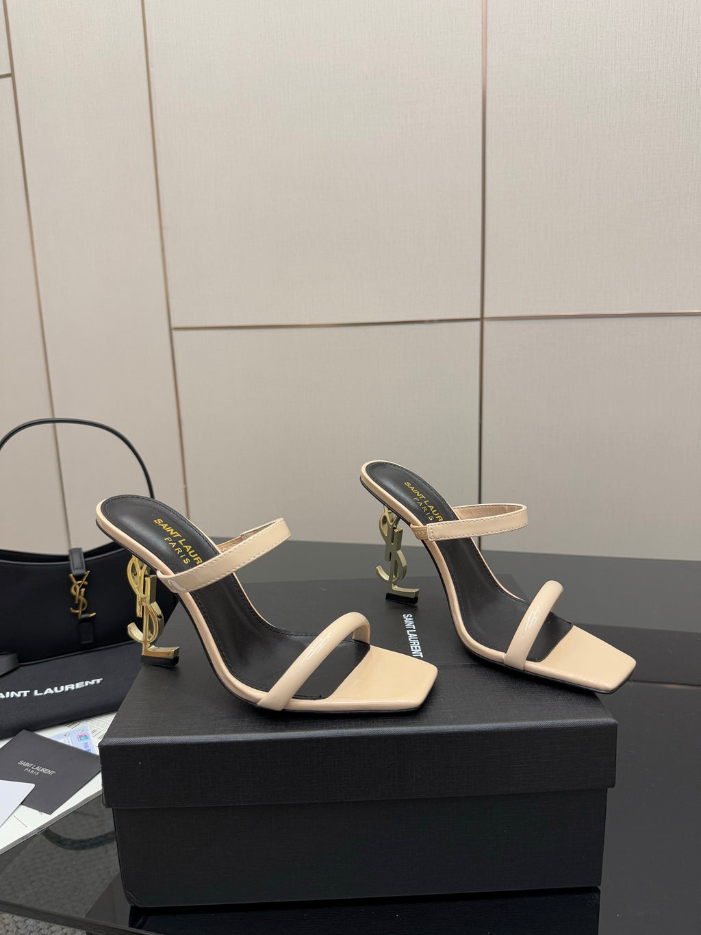 Two-tone heeled mule sandals, black lining with beige strap across the toes