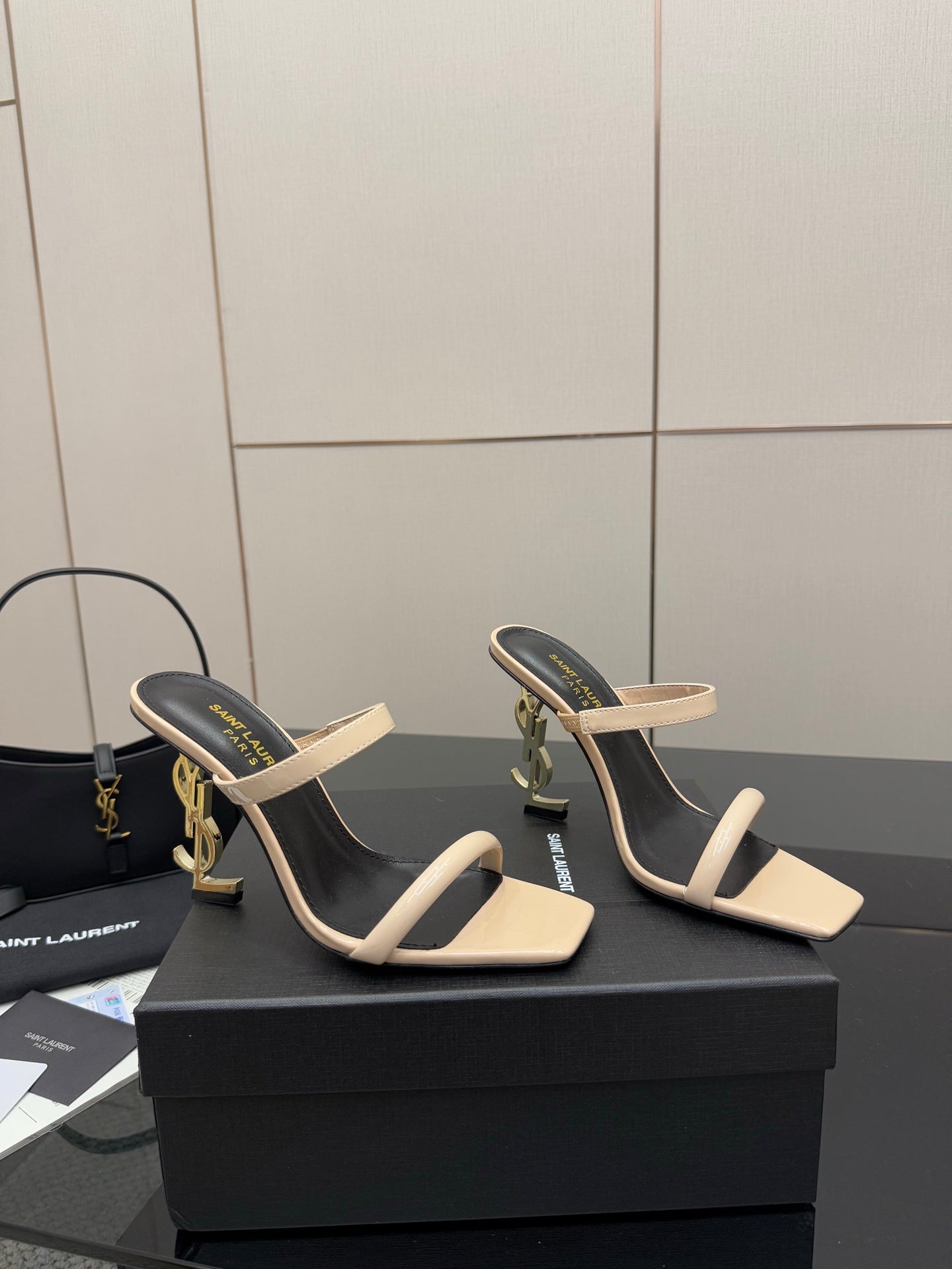 Two-tone heeled mule sandals, black lining with beige strap across the toes