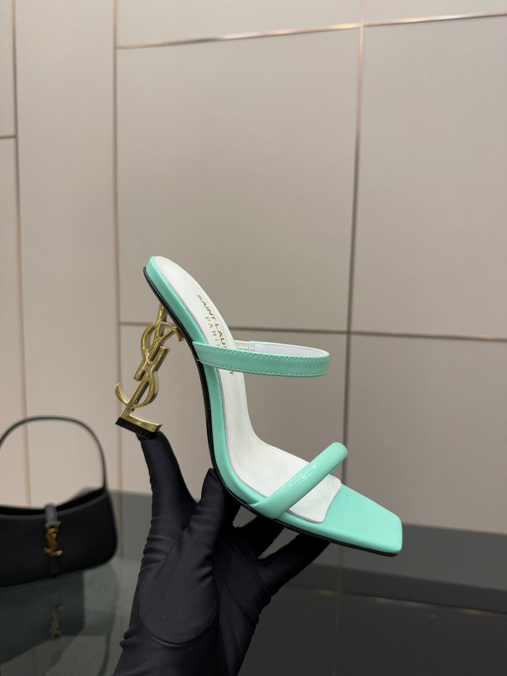 Mint green heeled mule sandal with open toe and gold heel logo