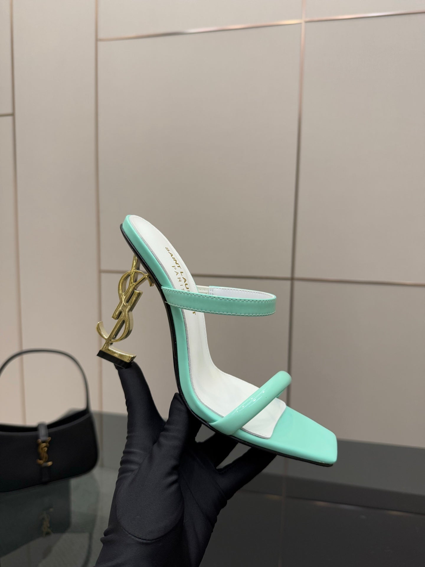 Mint green heeled mule sandal with open toe and gold heel logo