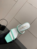 Mint green heeled mule with open toe strap and branded insole