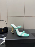 Mint green heeled mules with open toe, slim strap, and gold logo heel