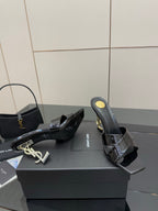 Black patent mule heel shoe with gold logo plate and stiletto heel