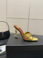 Yellow mule slide sandal with red insole and gold logo heel