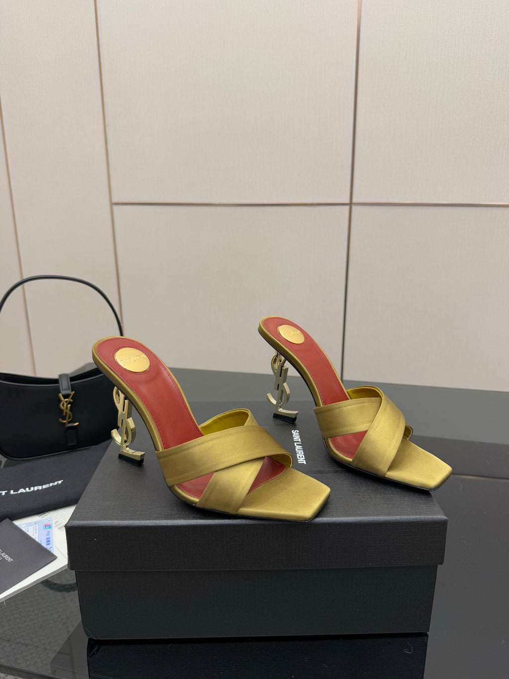 Yellow slide mule sandals with red insole and gold logo heel, open toe