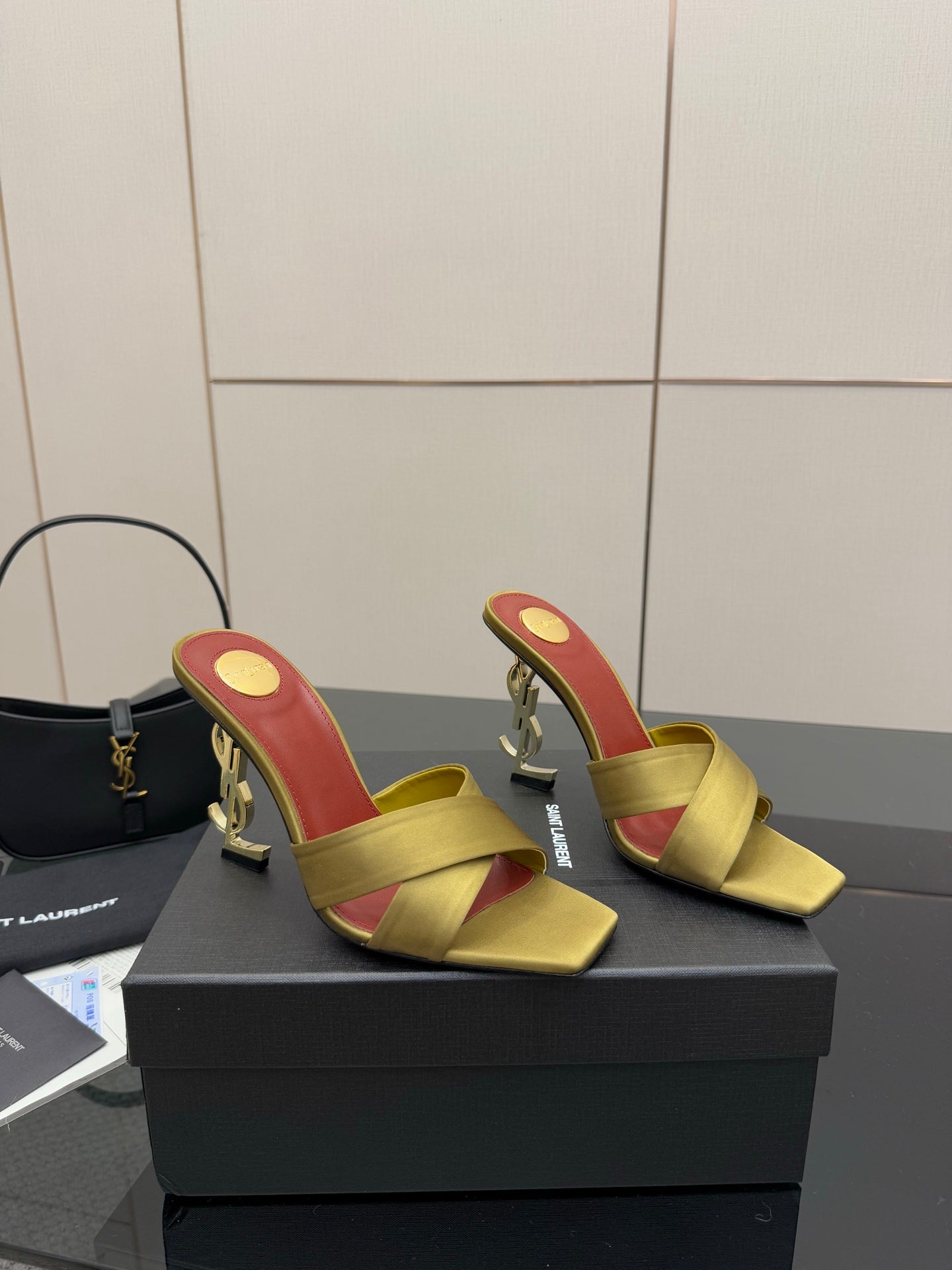 Yellow slide mule sandals with red insole and gold logo heel, open toe