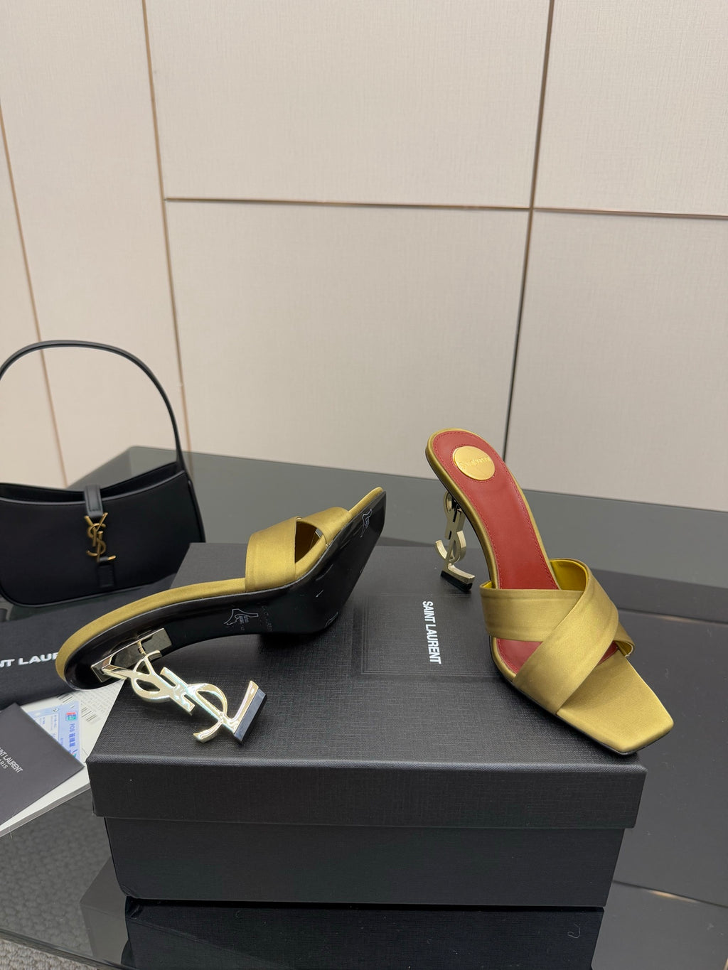 Yellow mule sandals with red insole and gold logo heel