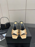 Cream and dark heeled mule sandals with gold YSL logo detail on heel, pair on box.
