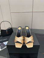 Cream and dark heeled mule sandals with gold YSL logo detail on heel, pair on box.