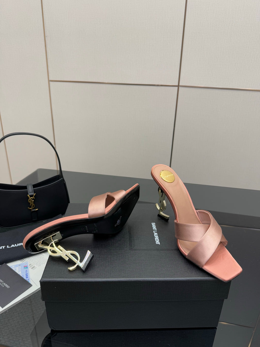 Pink YSL logo mule sandals, side view with open toe and low heel