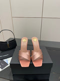 Pink YSL logo slide sandals with low heel and open toe, satin-like finish