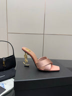 Pink YSL logo slide sandals, open toe mule with gold emblem on heel