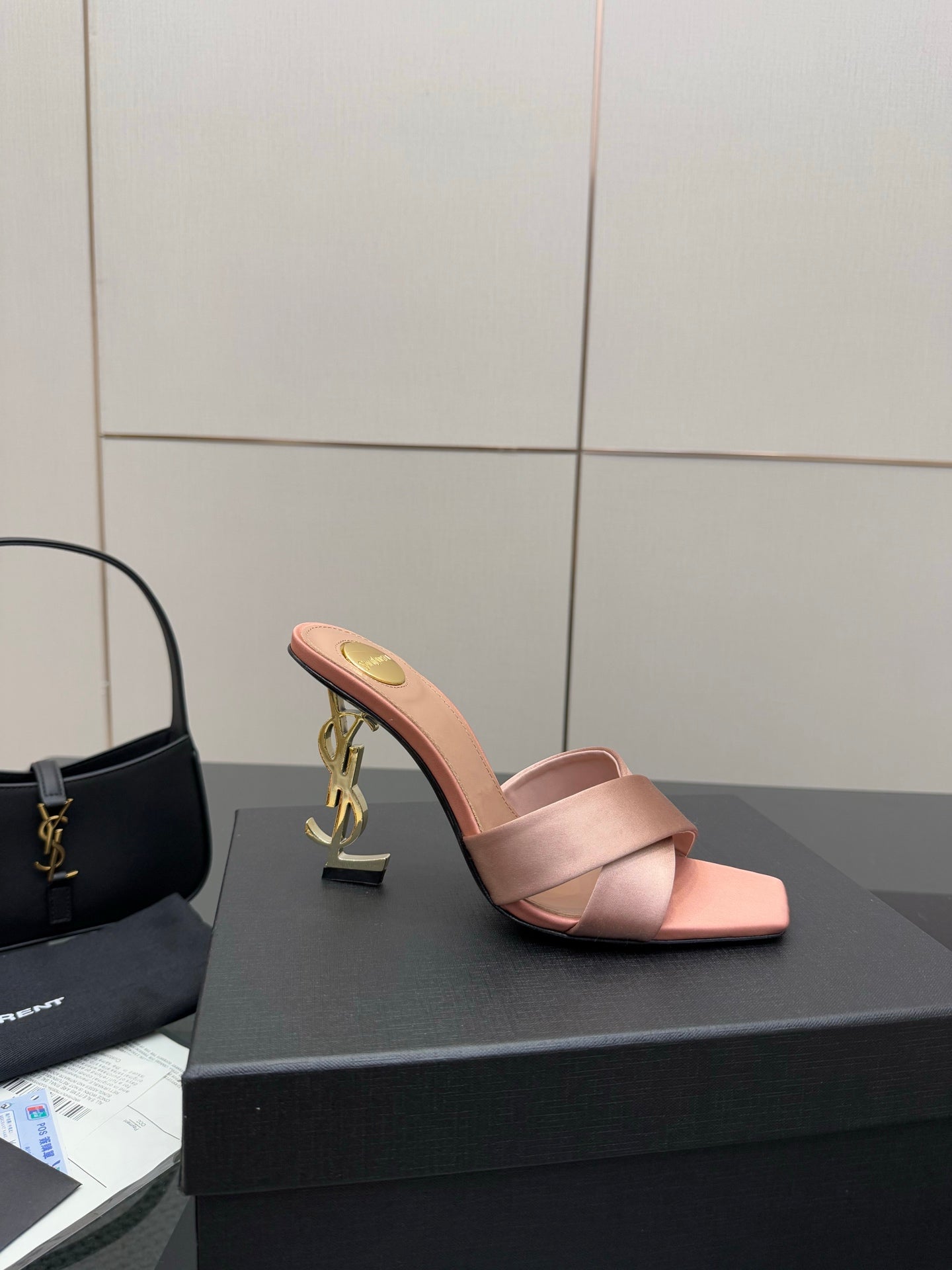 Pink YSL logo slide sandals, open toe mule with gold emblem on heel