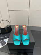 Teal YSL mule sandal with open toe and block heel, gold logo detail on heel
