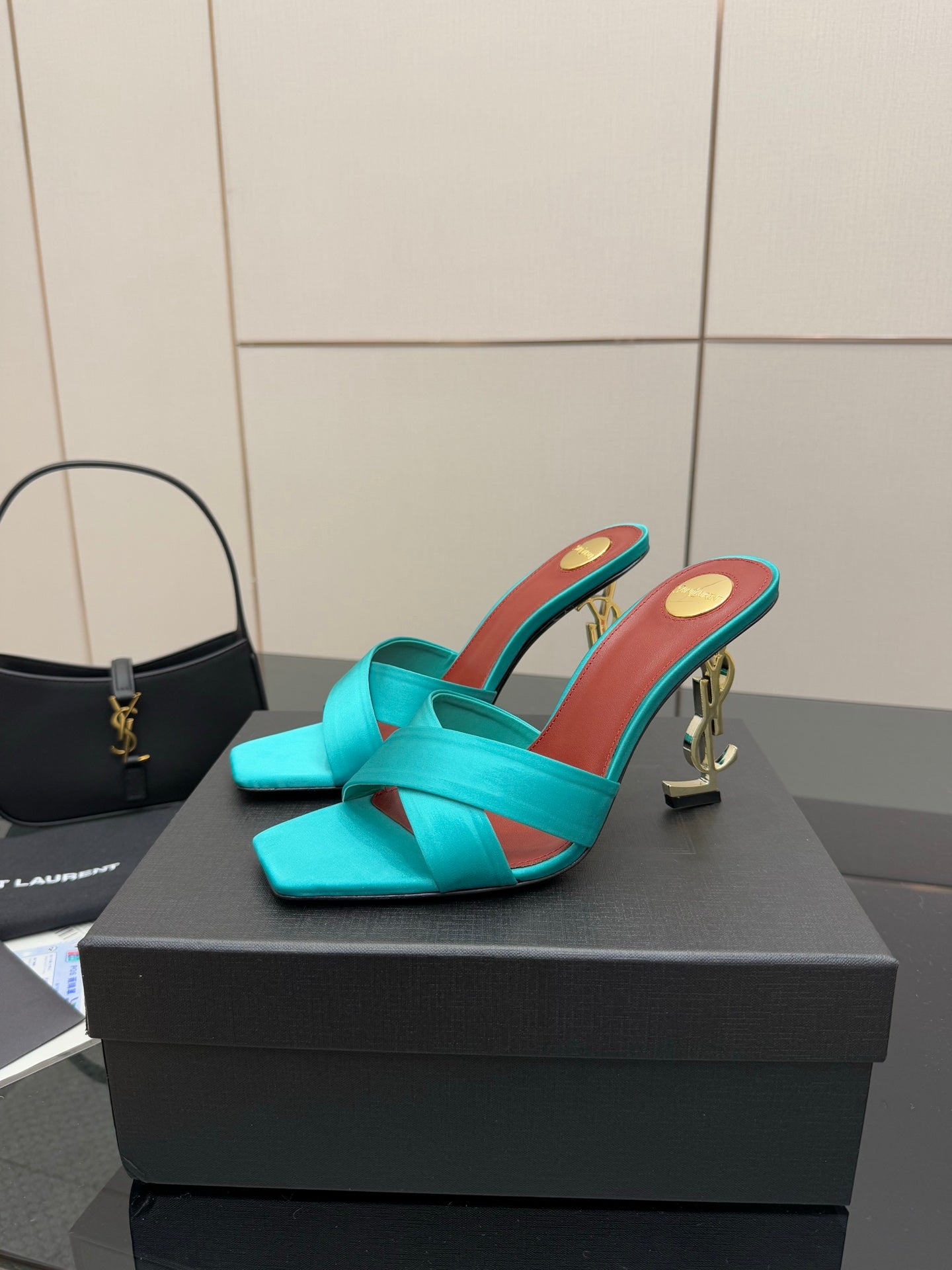 Teal YSL mule sandal with open toe and tall block heel, red-brown inner trim