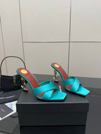 Pair of teal YSL mule sandals, open toe and mid-height block heels with gold accents