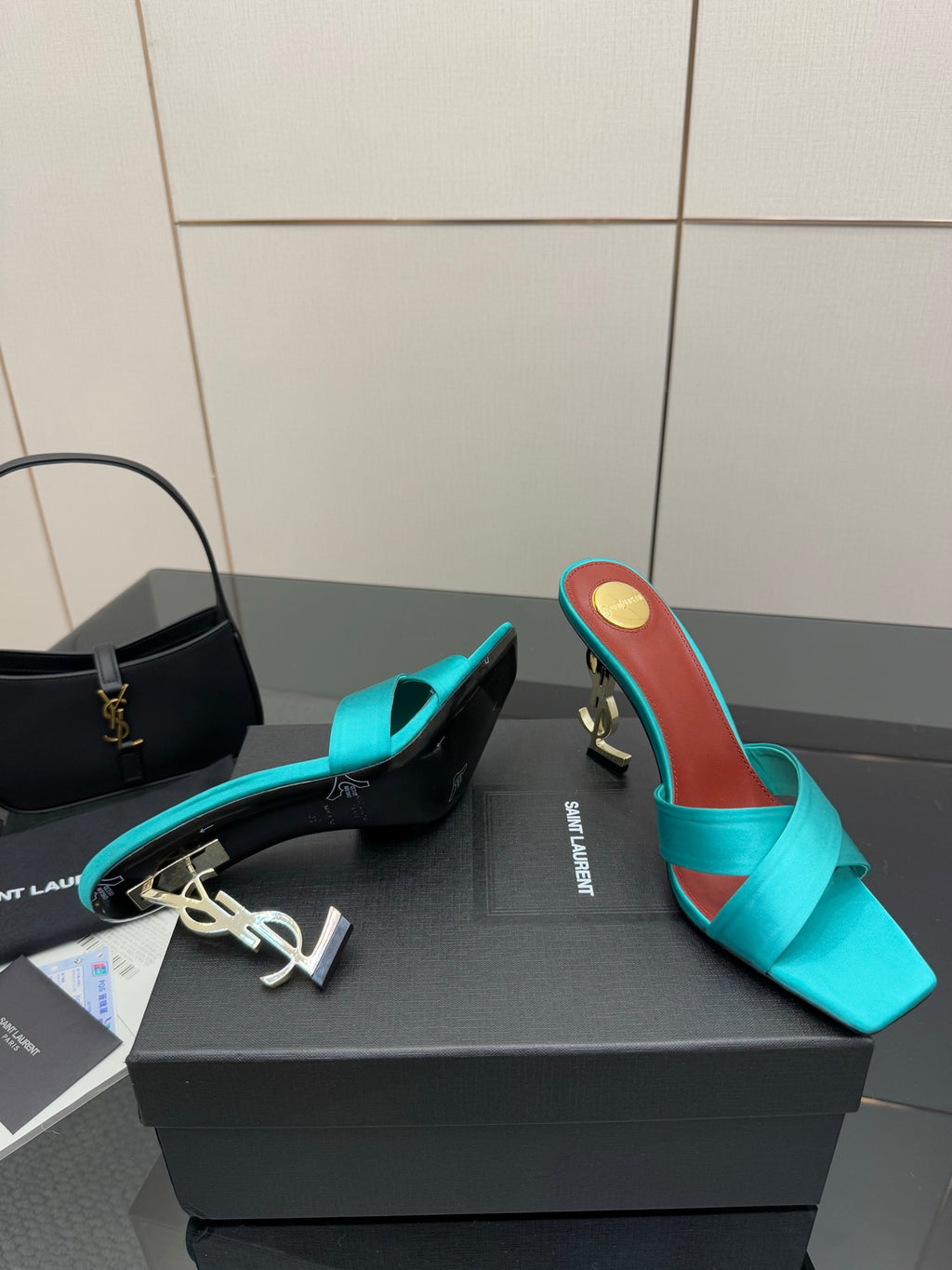 Teal YSL mule sandal with open toe and block heel, gold logo on the heel