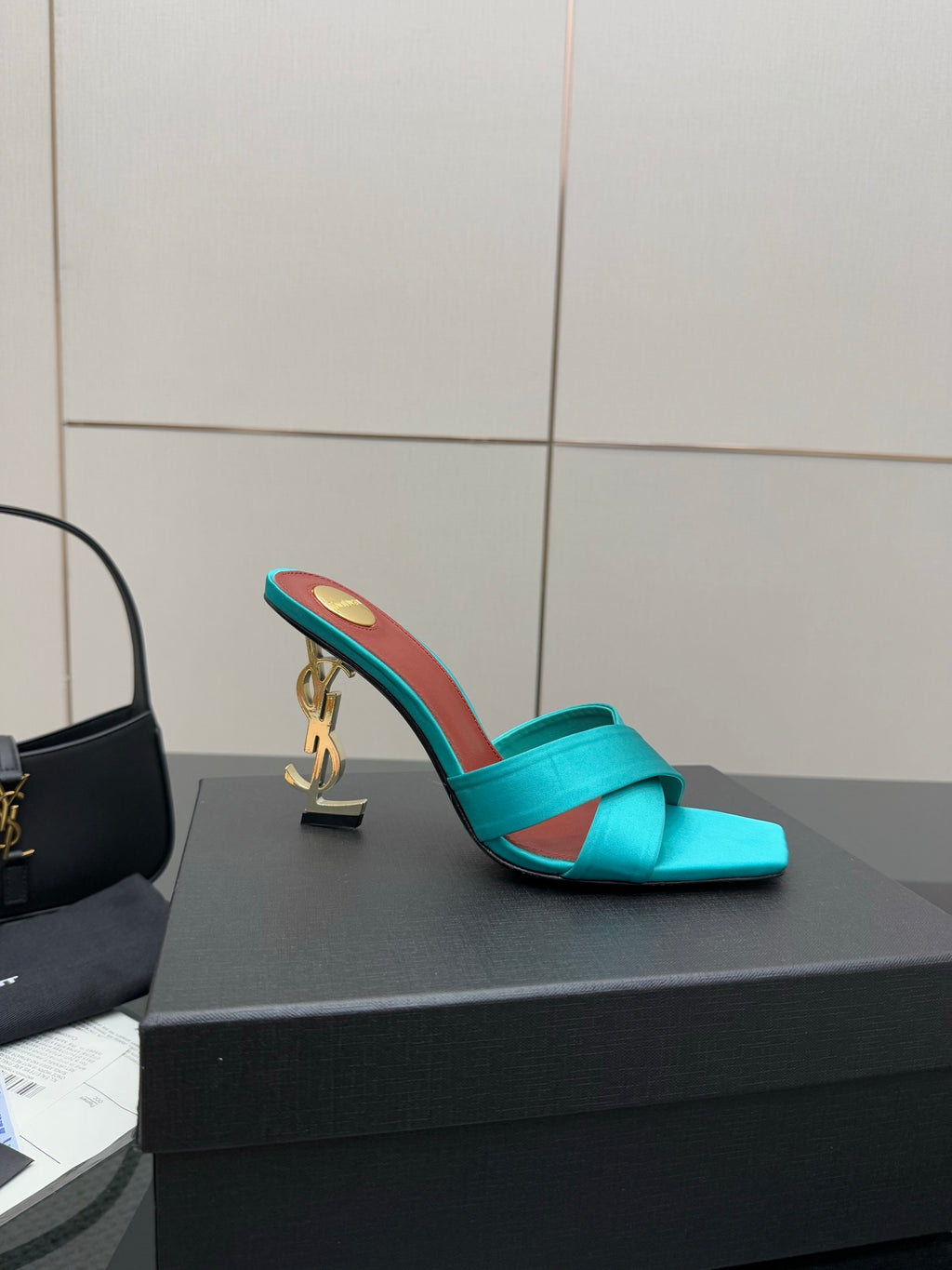 Teal YSL mule sandal with open toe and block heel, gold heel logo and red lining