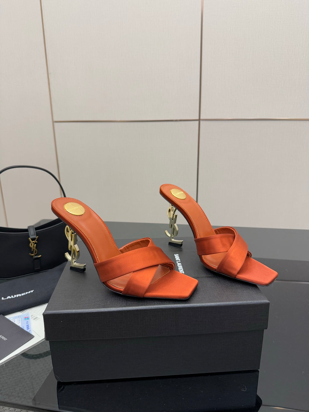 YSL orange mule sandals, open toe and ankle strap with gold logo detail on the heel