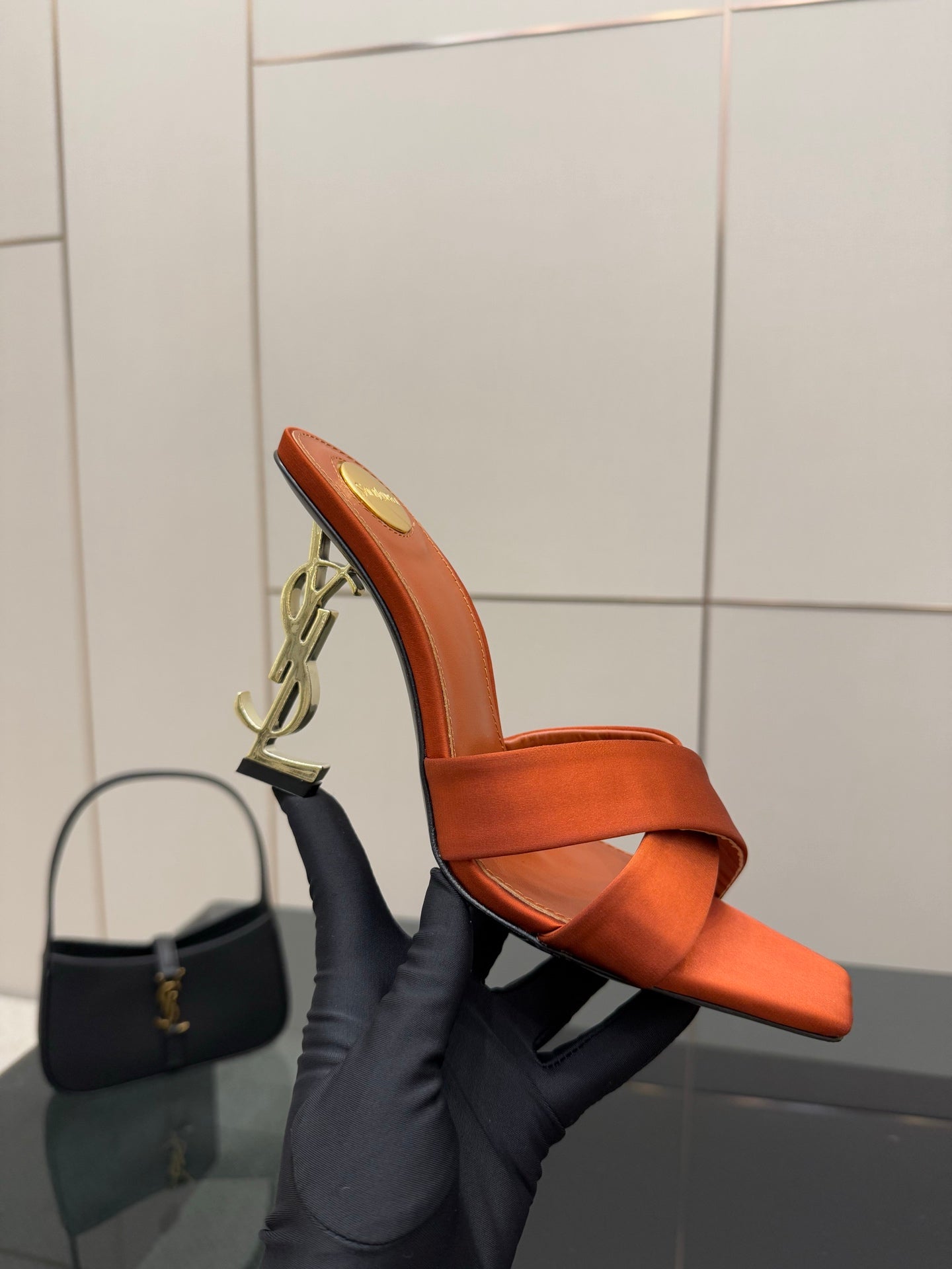 YSL orange mule sandals side view, open toe and crisscross strap with gold heel detail