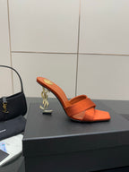 YSL orange mule sandals with open toe, high block heel, and gold logo accent