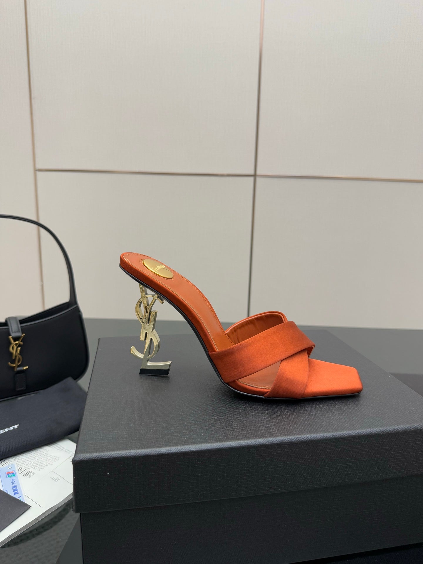 YSL orange mule sandals with open toe, high block heel, and gold logo accent