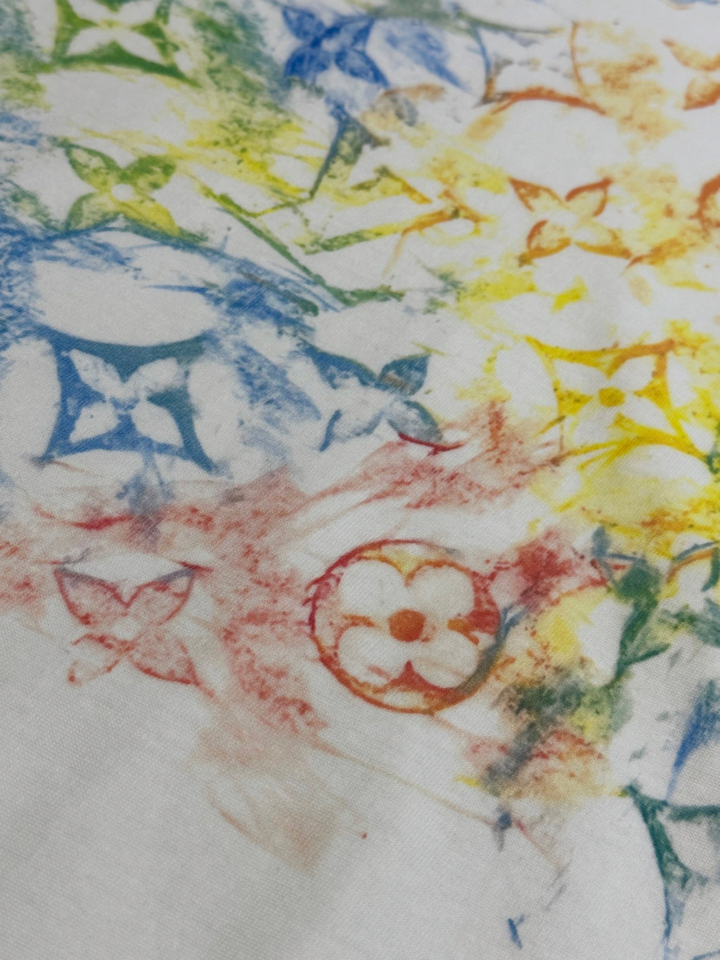 Multicolor graphic print on white T-shirt with blue, yellow, and red details