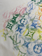 Multicolor graphic print on white T-shirt, featuring blue motif and green accents