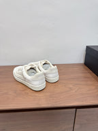 White sneakers shown from the back, with heel cushioning and lace-up closure