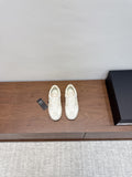 White low-top sneakers with lace-up front and textured leather-like upper