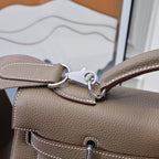 Hermes handbag taupe leather, close-up of strap hardware with D-rings and stitching